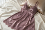 Vela Signature satin nightgown in mauve with lace trim laid on a bed
